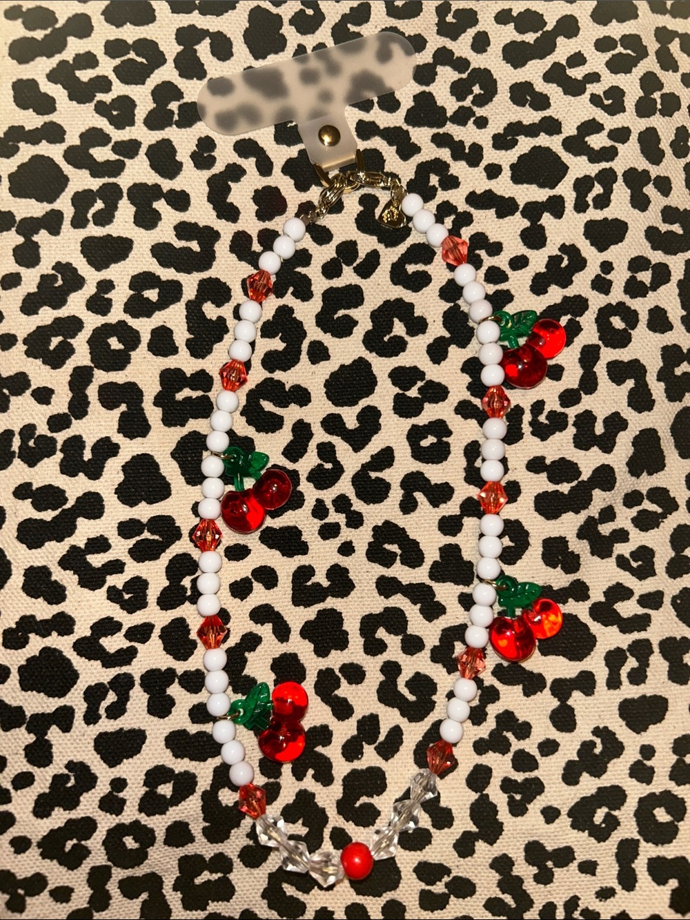 Velvet Caviar Red Cherry Beaded cell charm with White and Green Accents